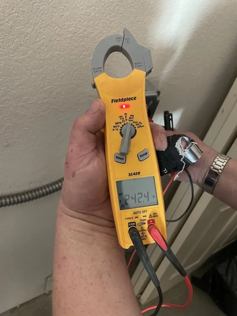Voltage testing with clamp meter during Outlet Installation in Villa Rica